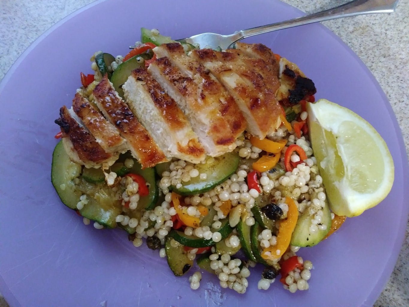 Seared Chicken Over Couscous with Zucchini Peppers and Caper-Butter Sauce